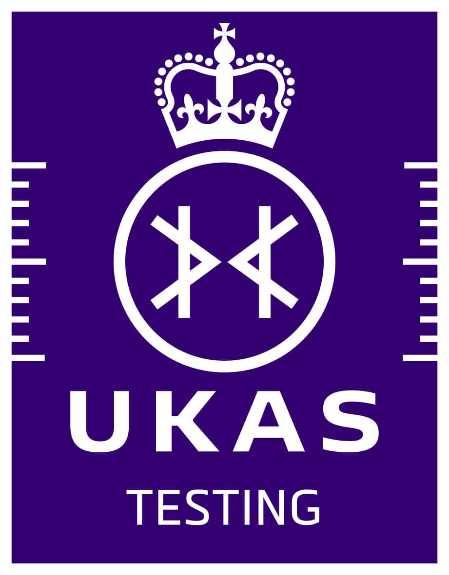UKAS Testing logo: a white crown above a circular symbol with abstract lines, all on a purple background, with UKAS in bold white letters and TESTING below. White vertical lines are on either side.